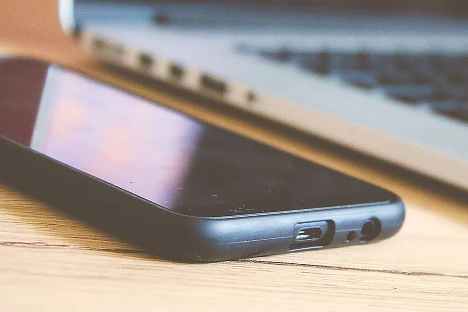 Smartphone and laptop on a desk