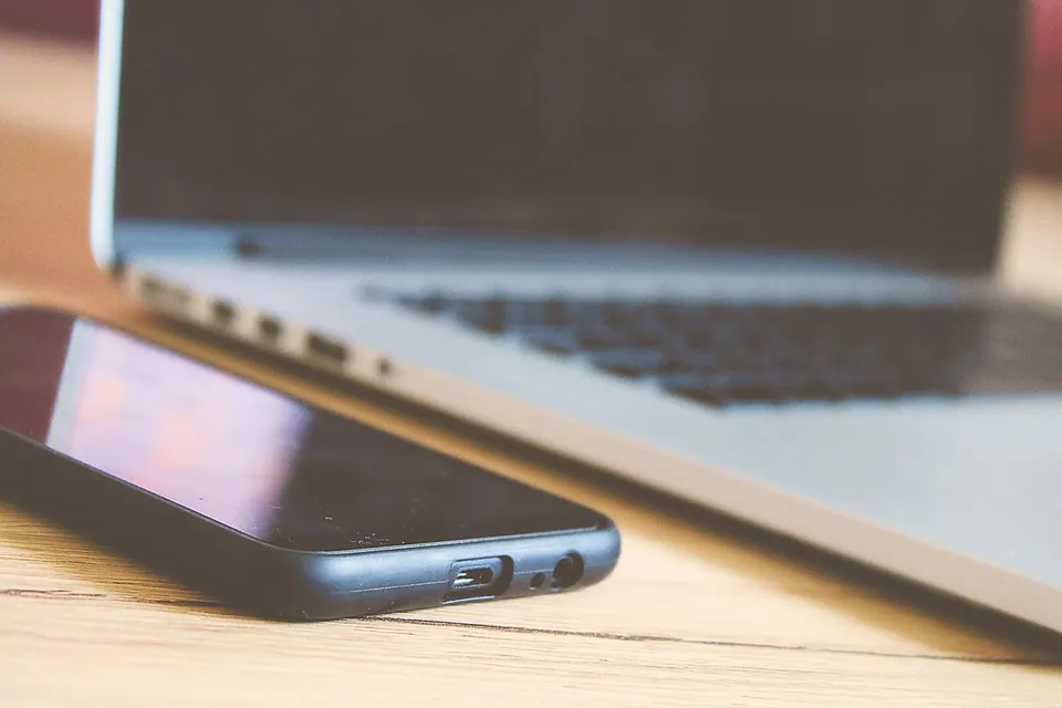 Smartphone and laptop on a desk