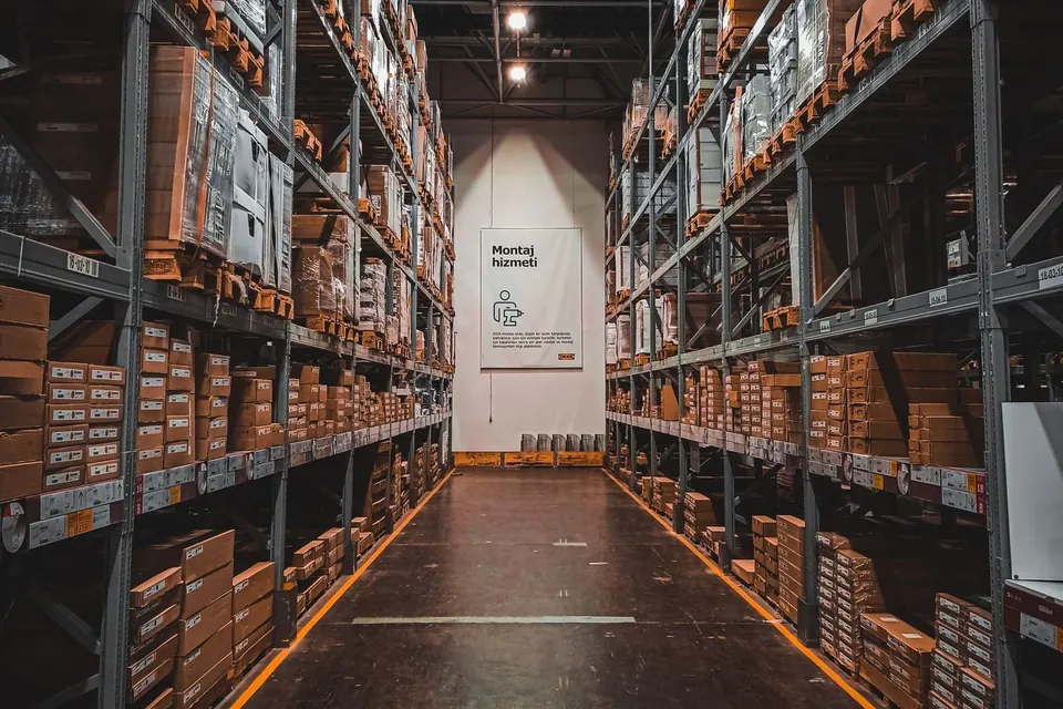 Shelves of boxed goods in a warehouse aisle